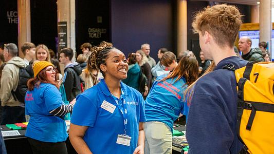 Student Ambassador talking to visitor at an open day