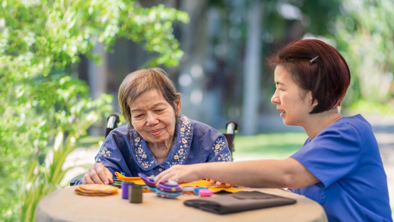 Health care practitioner working with an elderly patient with dementia