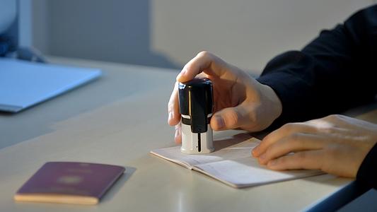 Passport being stamped by customs officer