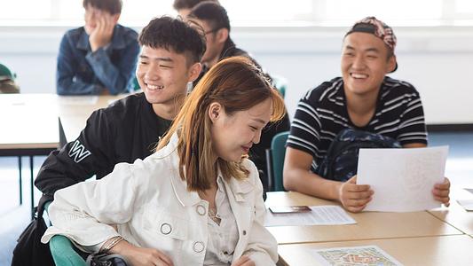 International students sat at a table completing forms at international welcome week.