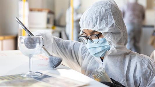 Sidney De Souza, Criminology Student, dusting for prints in the Murder House / Crime Suite (full-bleed)