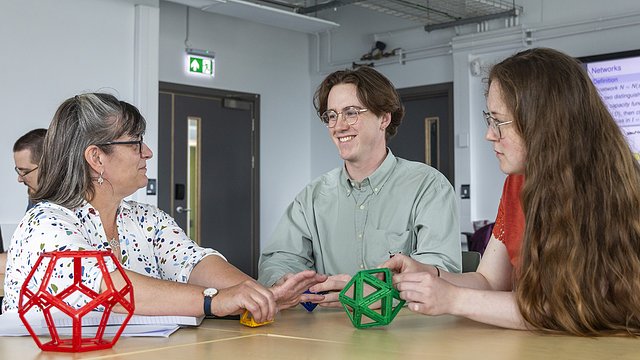 Mathematical Science students talking with academics 