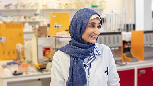 Female postgraduate student smiling in a lab