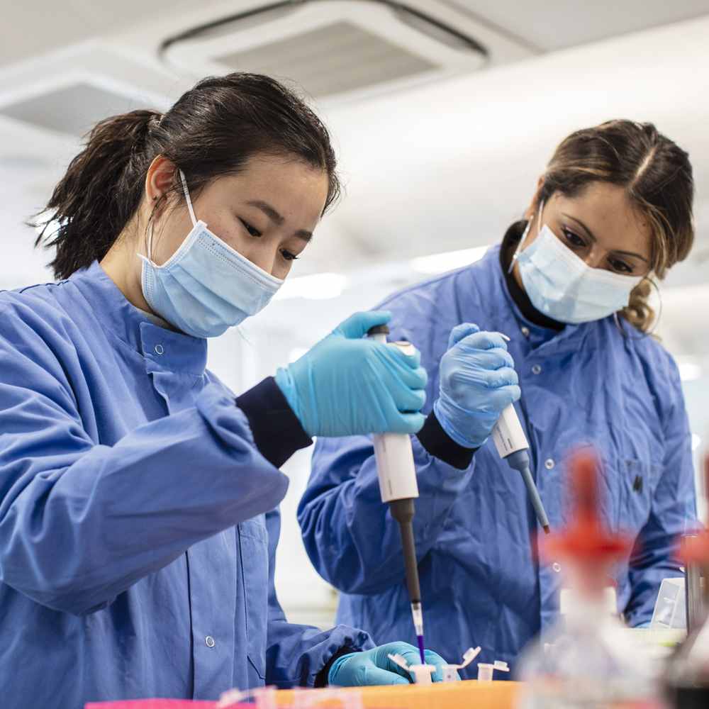 Tina Joshi working with biomedical student Christina in a lab